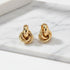 Gold Chunky Knot Stud Earrings pair on marble surface close-up | OriaJewel
