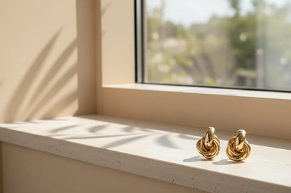 Gold Chunky Knot Stud Earrings on sunlit windowsill minimalist shot | OriaJewel