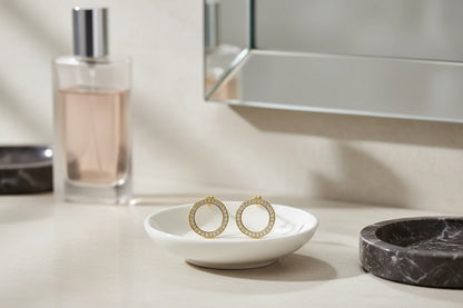 Gold Circle Stud Earrings on white dish vanity scene near mirror | OriaJewel