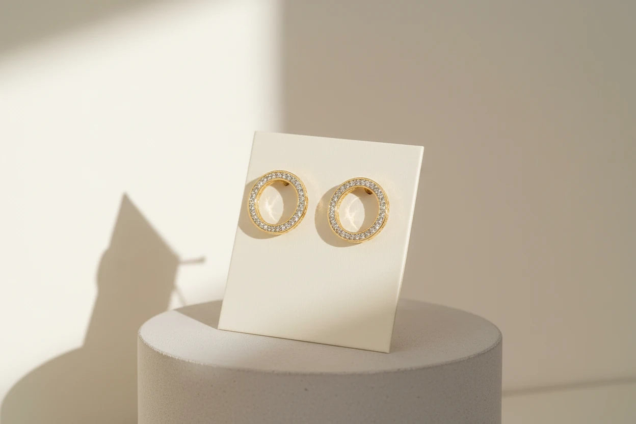 Gold Circle Stud Earrings on display card with sunlit shadows | OriaJewel