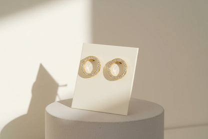 Gold Circle Stud Earrings on display card with sunlit shadows | OriaJewel