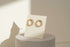 Gold Circle Stud Earrings on display card with sunlit shadows | OriaJewel