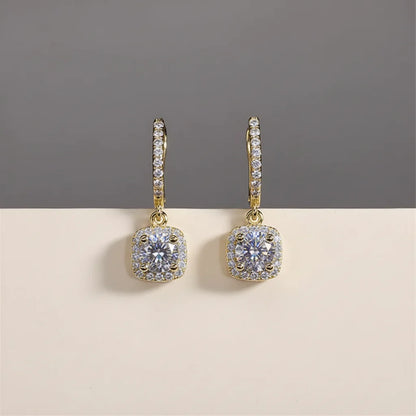 Gold Crystal Drop Huggie Earrings close-up front view on gray and beige backdrop | OriaJewel