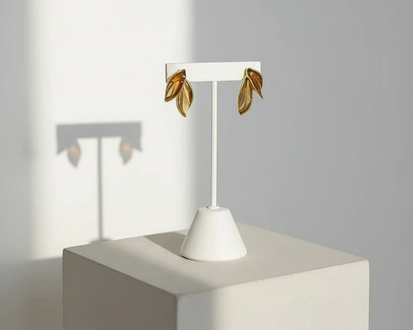 Gold Double Leaf Stud Earrings on white display stand with sunlit shadow | OriaJewel