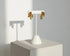 Gold Double Leaf Stud Earrings on white display stand with sunlit shadow | OriaJewel