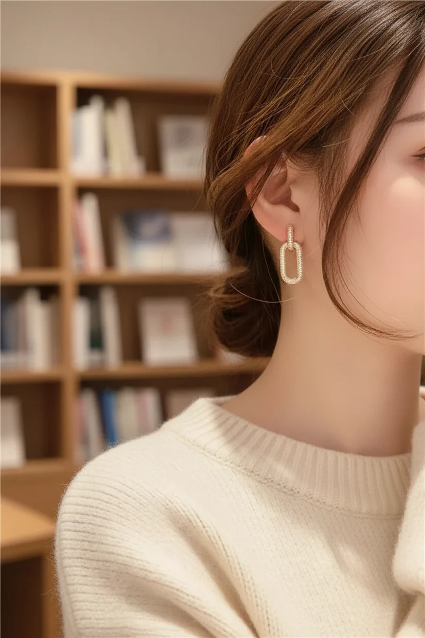 Gold Link Drop Earrings worn on model in cozy indoor setting | OriaJewel