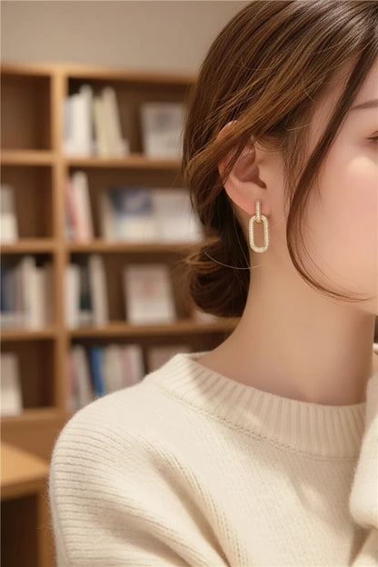 Gold Link Drop Earrings worn on model in cozy indoor setting | OriaJewel