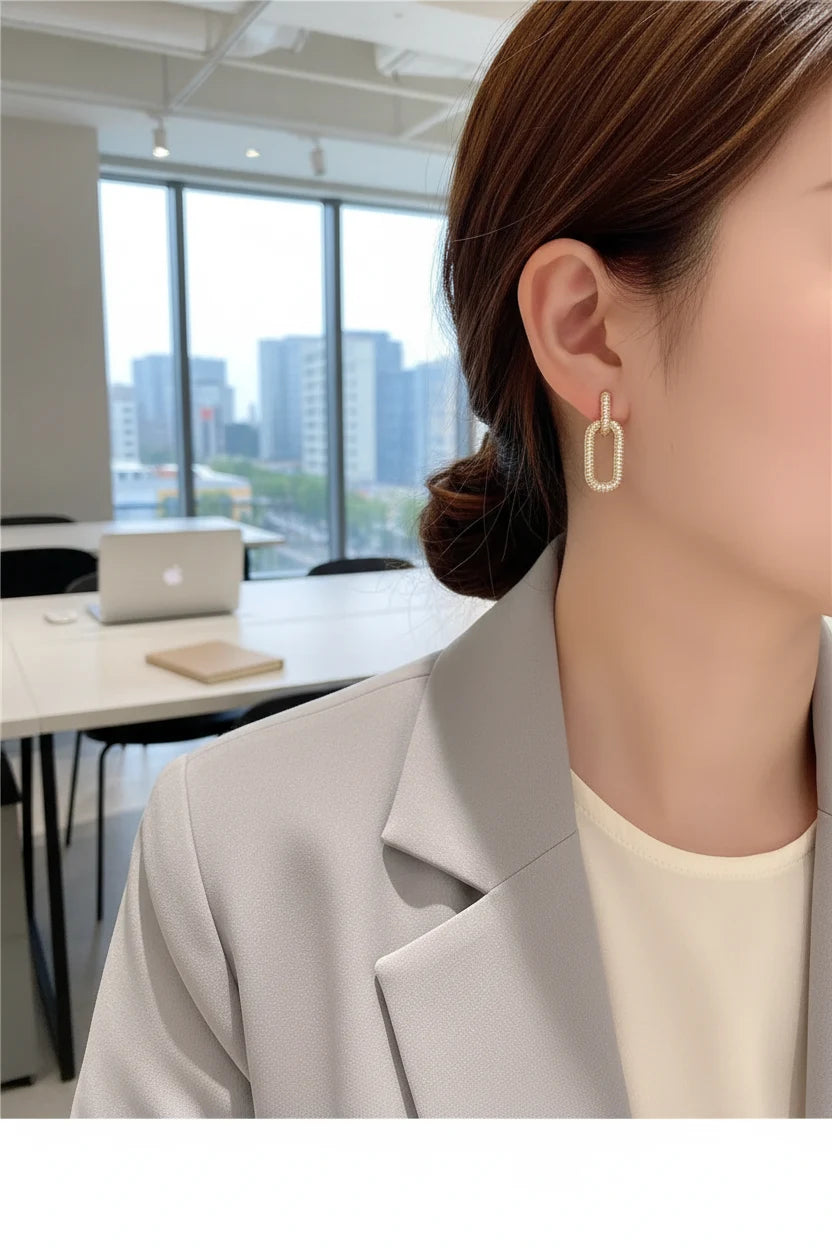 Gold Link Drop Earrings worn on model with blazer in modern office | OriaJewel