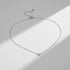 Silver version of Gold Love Pendant Necklace on fine chain in dramatic sunlight, casting soft shadow on neutral background | Oria Jewel