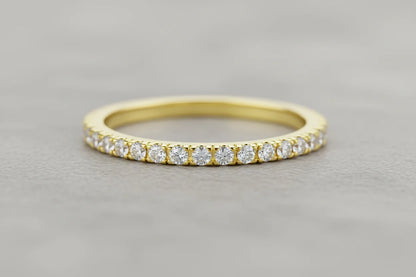 Close-up macro of a slim Gold Midi Ring Set band with a row of sparkling clear stones on a soft gray background | OriaJewel