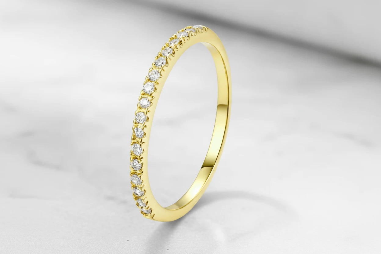 Minimal product shot of a delicate Gold Midi Ring Set shown upright, highlighting the thin band and stone-lined edge on a bright neutral surface | OriaJewel