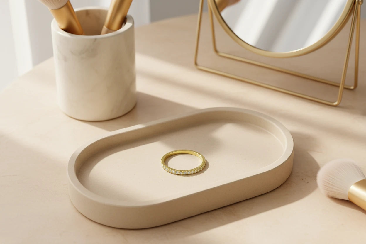 Gold Midi Ring Set placed on a modern vanity tray beside makeup brushes and a gold-framed mirror in warm natural sunlight | OriaJewel