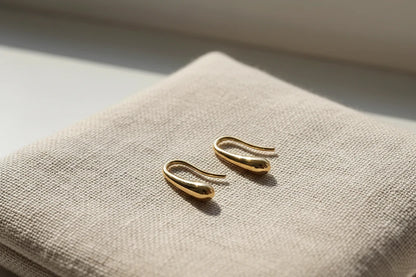 Gold Minimal Teardrop Hook Earrings close-up on linen fabric in soft light | OriaJewel