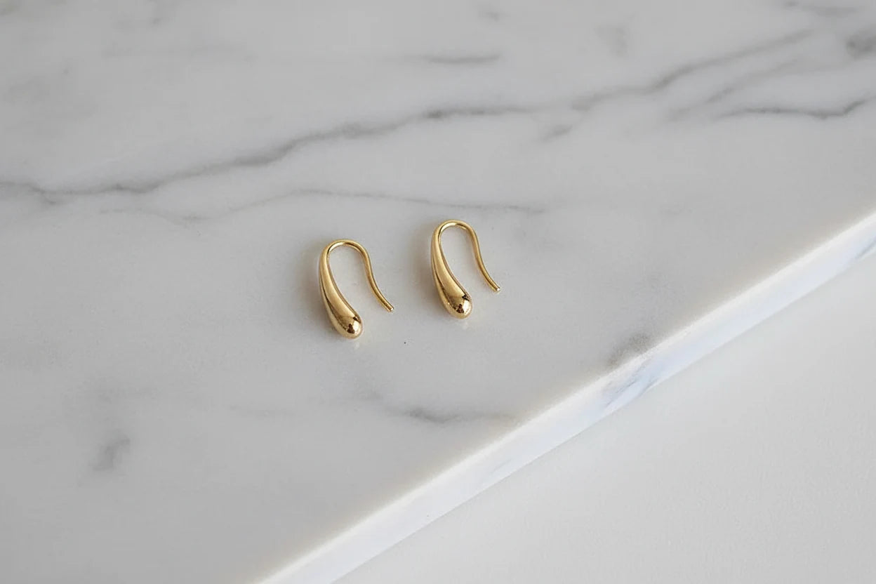 Gold Minimal Teardrop Hook Earrings pair on marble background close-up | OriaJewel