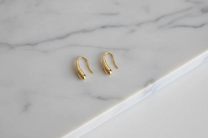 Gold Minimal Teardrop Hook Earrings pair on marble background close-up | OriaJewel