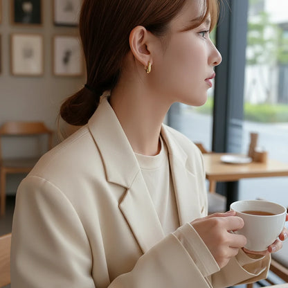 Gold Minimal Teardrop Hook Earrings worn on model holding coffee in cafe | OriaJewel
