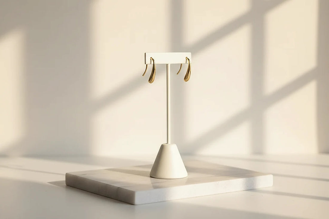 Gold Minimal Teardrop Hook Earrings on white stand with sunlit window shadows | OriaJewel