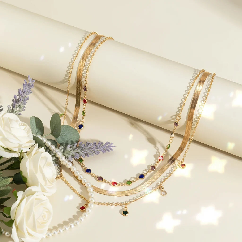 Gold Multilayer Choker Necklace featuring colorful gems and delicate chains, elegantly displayed with flowers | Oria Jewel