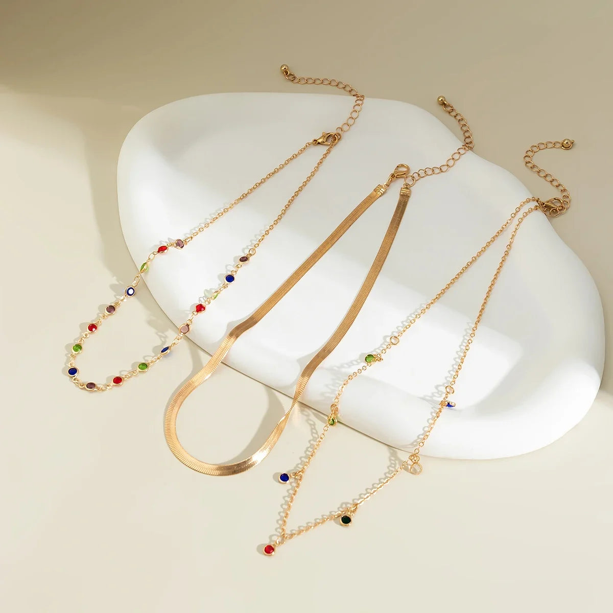 Gold Multilayer Choker Necklace showcasing delicate layers and colorful bead accents on a minimalist display | Oria Jewel