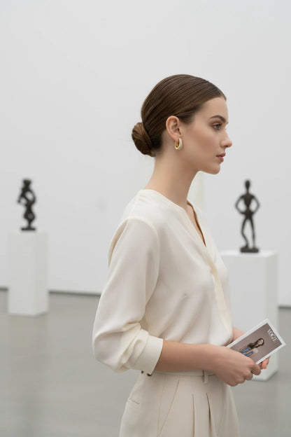 Gold Pavé Huggie Hoop Earrings worn on model in gallery setting | OriaJewel