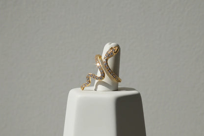 gold Pavé snake wrap ring on a white ring stand with a clean studio background | OriaJewel