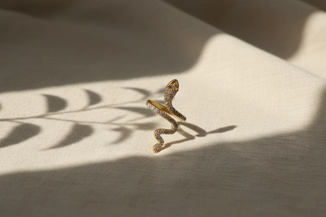 gold Pavé snake wrap ring standing on linen fabric with leaf shadows and warm light | OriaJewel