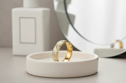 Clean vanity scene showing a Gold Silver Two Tone Band Ring upright in a white dish, soft-focus mirror and neutral decor, bright natural light | OriaJewel