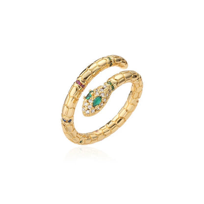 Gold Snake Wrap Ring isolated on a clean white background, showing the coiled snake wrap design with scale texture, pavé crystal head, and green stone eyes | OriaJewel