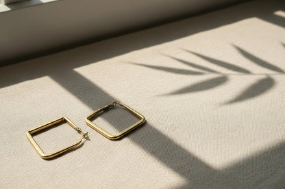 Gold Square Hoop Earrings on linen fabric with window shadow | OriaJewel