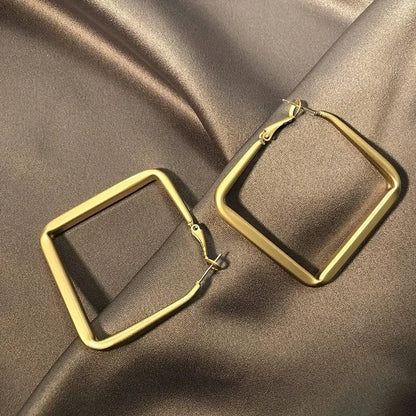 Gold Square Hoop Earrings on satin fabric flat lay close-up | OriaJewel
