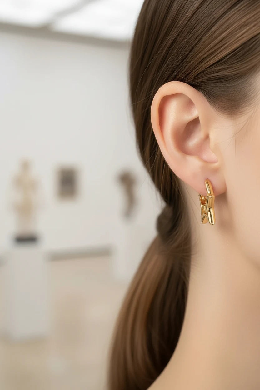 Gold Star Huggie Hoop Earrings worn by model close-up ear view | OriaJewel