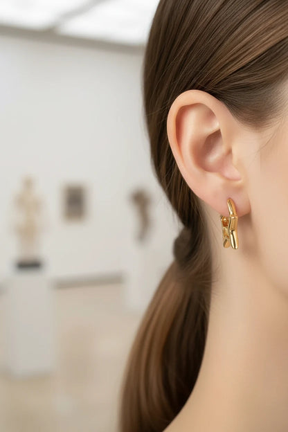 Gold Star Huggie Hoop Earrings worn by model close-up ear view | OriaJewel