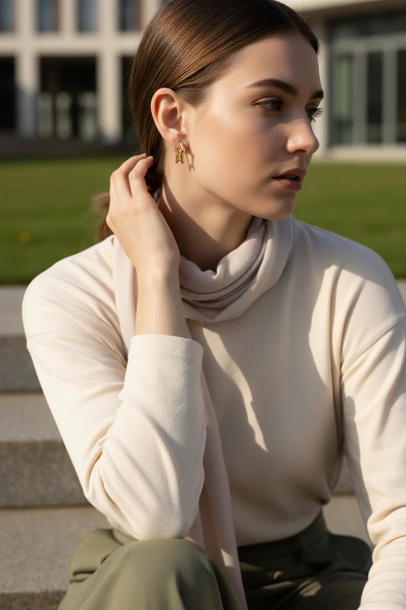 Gold Star Huggie Hoop Earrings worn by model outdoors in sunlight | OriaJewel