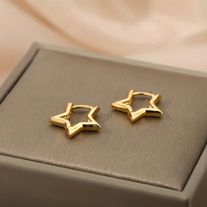 Gold Star Huggie Hoop Earrings close-up pair on jewelry box | OriaJewel