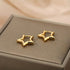 Gold Star Huggie Hoop Earrings close-up pair on jewelry box | OriaJewel