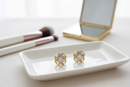 Gold Tone Knot Halo Stud Earrings on vanity tray with makeup brushes | OriaJewel