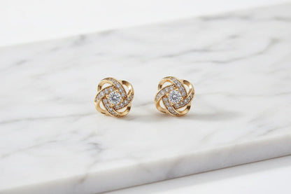 Gold Tone Knot Halo Stud Earrings close-up on marble surface | OriaJewel