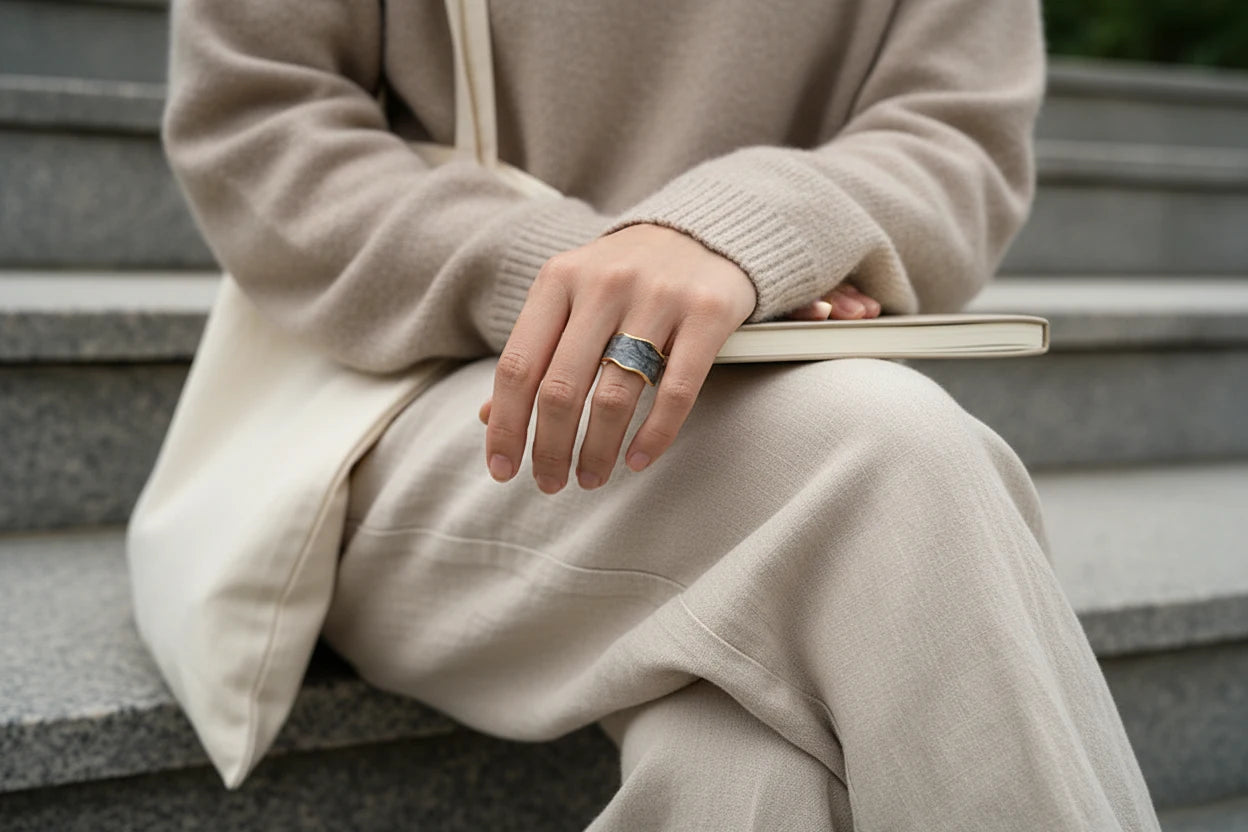 Gray Marble Open Wave Ring worn on hand turning a book page, cozy neutral outfit background | OriaJewel