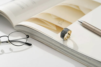 Gray Marble Open Wave Ring product shot on an open magazine with pen and glasses | OriaJewel