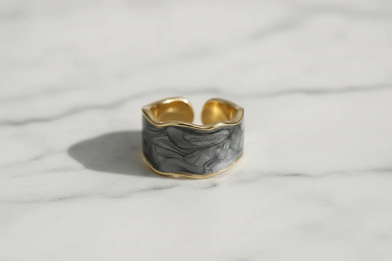 Gray Marble Open Wave Ring close-up on white marble surface showing the adjustable open band | OriaJewel