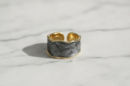 Gray Marble Open Wave Ring close-up on white marble surface showing the adjustable open band | OriaJewel