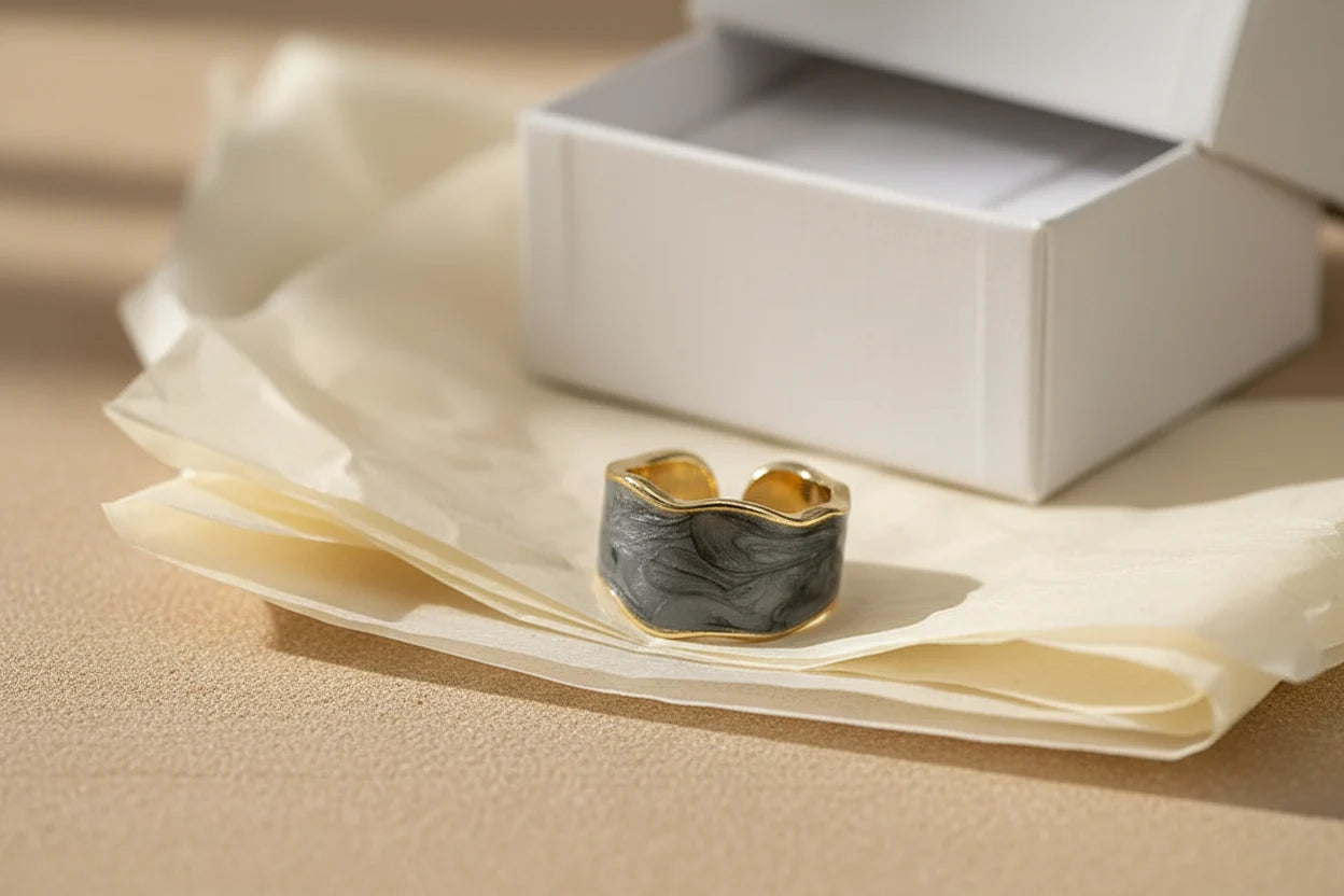 Gray Marble Open Wave Ring on tissue paper beside a gift box, warm minimal styling | OriaJewel