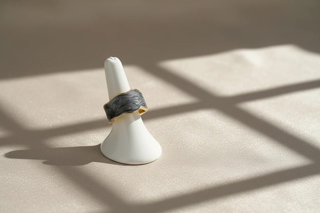 Gray Marble Open Wave Ring displayed on a white ring stand with bright geometric light shadows | OriaJewel