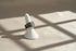 Gray Marble Open Wave Ring displayed on a white ring stand with bright geometric light shadows | OriaJewel
