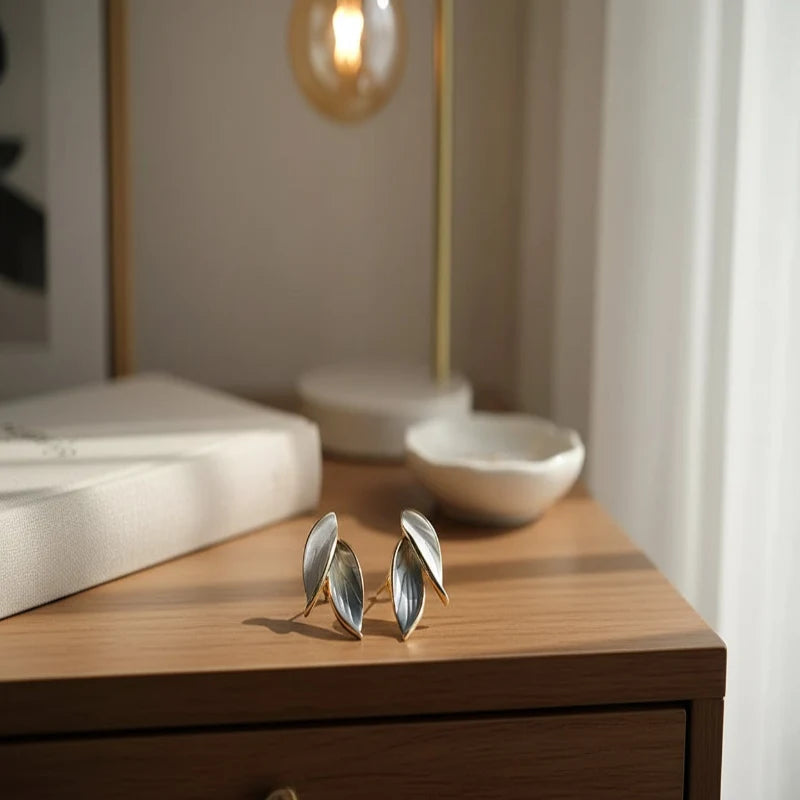 Gray Double Leaf Stud Earrings on wooden bedside table in soft sunlight | OriaJewel