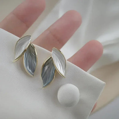 Gray Double Leaf Stud Earrings close-up on hand holding earring card | OriaJewel