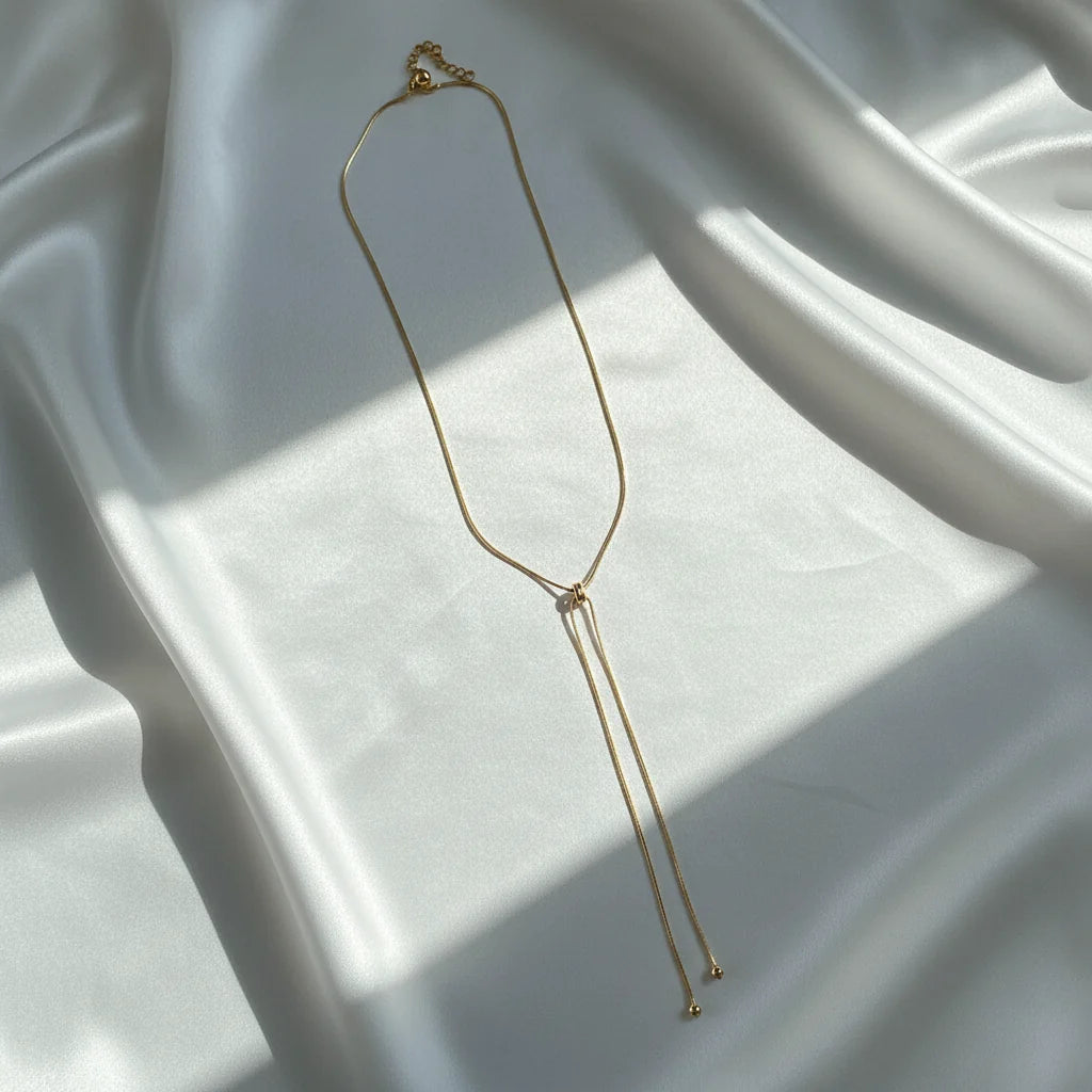 Kpop Snake Pendant Necklace featuring a minimalist gold chain design on a satin background | Oria Jewel