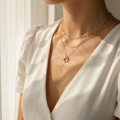 Layered Choker Necklace in gold styled with white V-neck dress under soft daylight showing elegant minimal layers | Oria Jewel