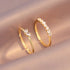 Luna Dainty Stack Ring Set styled on soft satin fabric, close-up of the two delicate gold stacking rings with a marquise crystal accent and a half-eternity row of round stones | OriaJewel