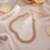 Luxury Rhinestone Chain Choker in rose gold placed on satin fabric with flower petals, exuding feminine charm | Oria Jewel